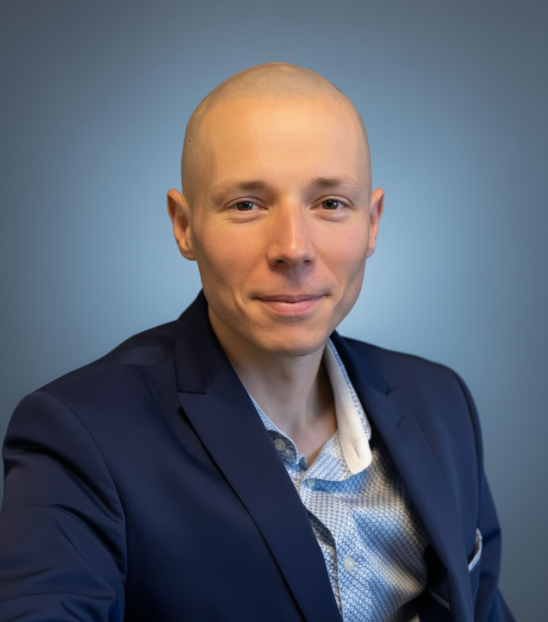 Professional headshot of a construction cost consultant wearing a suit, neutral office background, soft natural light, confident friendly expression, high quality photo